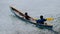 Silhouette of two local boys in a boat on Arborek Island in Raja Ampat, West Papua, Indonesia, near the famous Manta