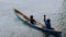 Silhouette of two local boys in a boat on Arborek Island in Raja Ampat, West Papua, Indonesia, near the famous Manta