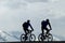 Silhouette two mountain bikers