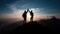 Silhouette of two travelers or hikers standing and raise their hands together on the top of mountain with a dusk sky and enjoys