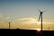 Silhouette of Two Wind Turbines at Dawn. UK