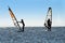 Silhouette of a two windsurfers