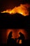 Silhouette of two women watching Forest Fire. Night fire in the