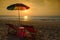 Silhouette umbrella at the beach and sunset