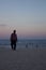 Silhouette of unidentifiable man walking on the beach copacabana rio de janeiro