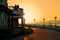 Silhouette of unidentified buildings during sunrise sunset with dramatic orangish color sky