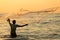 Silhouette of the unidentified Indian fisherman throwing net in sea