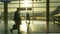 SILHOUETTE Unrecognizable tourists hurry up and down Frankfurt airport at sunset