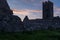 A silhouette view of the ruins of Clare Abbey a Augustinian monastery just outside Ennis, County Clare, Ireland at sunset