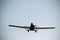 Silhouette of a vintage single-engine aircraft with a propeller flying in a perfectly clear sky