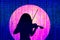 Silhouette of a violinist girl against the background of the rising sun. The background of musical notes falls like rain.