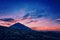 Silhouette of volcano del Teide against a sunset sky. Pico del Teide mountain in El Teide National park at night.