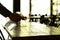 Silhouette waiter cleaning the table with disinfectant spray