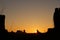 Silhouette of western buttes against sunset