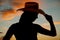 Silhouette western woman hat tip close