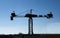 Silhouette of white stork nesting over old construction crane