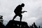 Silhouette of a wild rock guitarist crowdsurfing on a guitar case