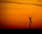 Silhouette of wind turbine at sunset