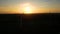 Silhouette of a windmill in the sun. Aerial close up shot of wind mills rotating by the force of the wind and generating renewable