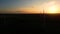 Silhouette of a windmill in the sun. Aerial close up shot of wind mills rotating by the force of the wind and generating renewable