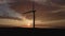 Silhouette of windmill turbine in field at sunset sky. Rotating wind generator