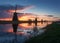 Silhouette of windmills at sunrise in Kinderdijk, Netherlands