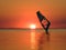 Silhouette of a windsurfer on waves of a gulf