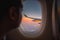 Silhouette wing of an airplane at sunrise view through the window