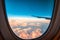 Silhouette wing of an airplane at sunset view through the window