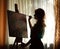 Silhouette woman artist drawing paint picture on easel indoors