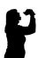 Silhouette of woman biting hamburger