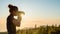 Silhouette of woman with camera. Woman takes photo of La Gomera Island in the rays of the setting sun. Tenerife Island