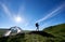 Silhouette of woman climber near camping against blue sky in the morning