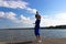 Silhouette of the woman dancing at the beach during beautiful sunrise. Natural light and darkness