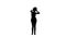 Silhouette woman dancing with her hands on her head