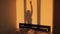 Silhouette of woman dancing sensually on sunset light. Reflection of the shadow on the wall.