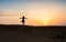 Silhouette of a woman in the desert at sunset