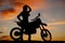 Silhouette woman by dirt bike hand head