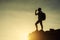 Silhouette woman drink water to cliff in sunset