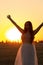 Silhouette woman figures at sunset standing on hay stack, beautiful romantic girl with long hair posing outdoors in field