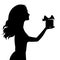 Silhouette of woman holding a gift box