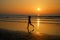 Silhouette of woman jogger running on sunset beach with reflection, fitness and sport