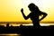 Silhouette of a woman jogging on nature at sunset, sports female profile, concept of sport, leisure and healthcare