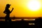 Silhouette of a woman jogging on nature at sunset, sports girl profile, concept of sport and leisure