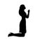 Silhouette woman kneeling praying