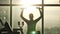 Silhouette of woman middle age doing exercise with dumbbells.