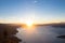 Silhouette of a woman observing the lake shore from the balcony of a viewpoint in the early hours of the morning with a beautiful