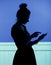 Silhouette of woman playing the cell phone