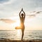 Silhouette of a woman practicing the tree yoga pose on a beach a