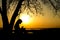Silhouette of woman praying to God in the nature witth the Bible at sunset, the concept of religion and spirituality